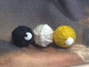 Close up of three finished buttons by Ceara.