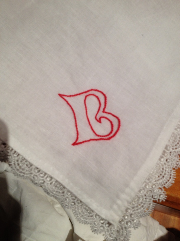 Stem stitch monogram for Queen Beatrice that I embroidered onto a linen handkerchief I hemmed and added pre-made cotton lace to as a gift from the Barony of Politarchopolis to Their Majesties when they visited Fields of Gold.