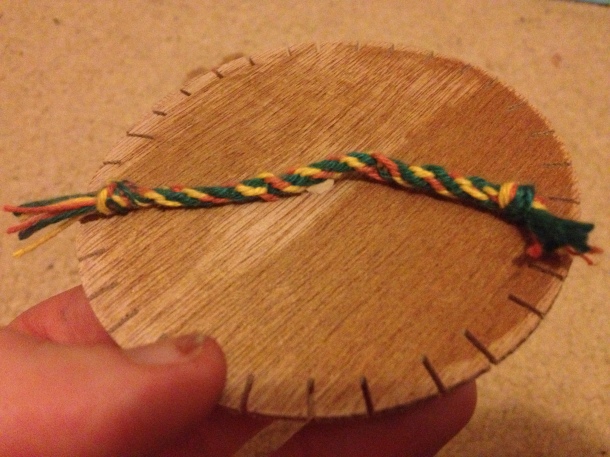 Me learning how to make braid with a wheel (first attempt).