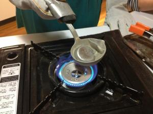 The pewter or lead is melted over a gas stove top.