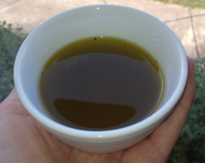 The finished oil. It smelt a little too strongly of olive oil, and not strongly enough of roses. It would probably have held a scent better if I had time to repeat the infusion process many times.