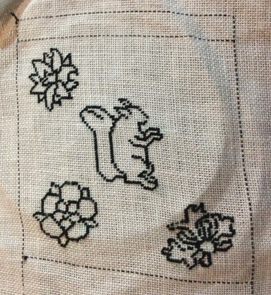 Columbine flower outline (top left), squirrel, rose (bottom left) and honeysuckle (bottom right) in black tent stitch.