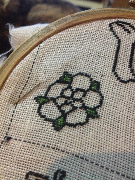 Rose outline with two shades of green infill added for the leaves. All in silk tent stitch.