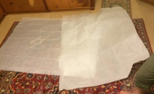 Figure 4: Pattern paper was laid out and taped together to cover an area larger than would be required for the skirt. I needed two large pieces of this particular paper to map out my skirt. Photo by Ceara Shionnach, 2014.