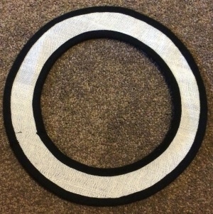 Figure 8: both the outer and inner edges of the buckram brim have had black cotton bias tape sewn over the milliners wire. This secures the wire, will prevent the imprint of the wire showing through the velvet, and will prevent the ends of the wire from poking through the velvet in the future.