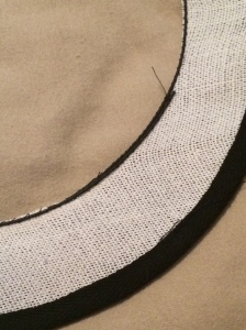 Figure 7: the outer edge of the buckram brim has had black cotton bias tape sewn over the milliners wire. The inside edge now also has milliners wire couched to it.