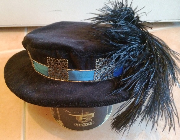 Figure 9: The hat before it was lined, showing the blue silk band, gold twist couching and filigree metal squares.