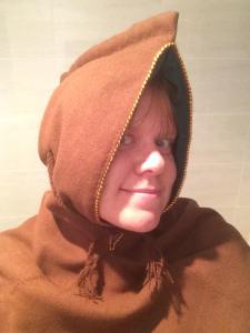 Me, wearing the finished hood for Haos, demonstrating the ties done up at the front - Ceara Shionnach, 2015.