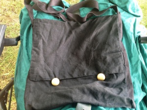 The outside of Saunooke's bag is black with gold-coloured buttons.