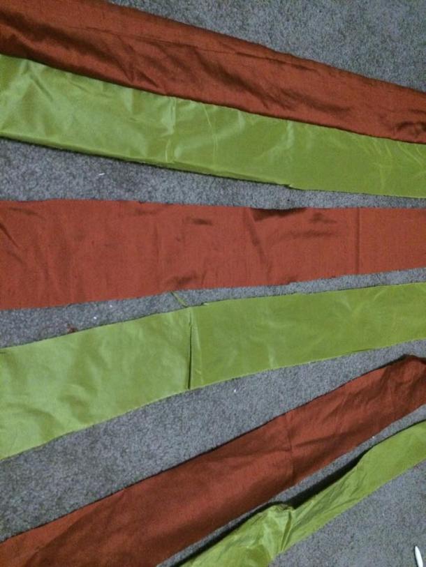The two coloured silks were torn into 3 inch (plus 2cm seam allowance) strips. Photo by Ceara Shionnach, April 2015.