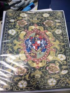 The book of ceremonies cover that I made from combining a period image with Lochac's Kingdom arms.