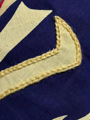 Figure 5: Chain stitch in progress around the appliqué tail of the raven by Ceara Shionnach (2016).