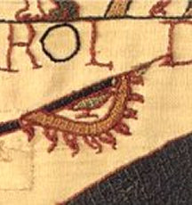 Figure 4: Banner, Bayeux Tapestry, 11th century – The Bayeux Tapestry depicts a semi-circular banner on a spear that has nine tabs, a thick yellow border, and a bird in the centre (potentially a raven). Despite being held by a Norman, the banner may have origins/links with Vikings. Source: Viking Answer Lady